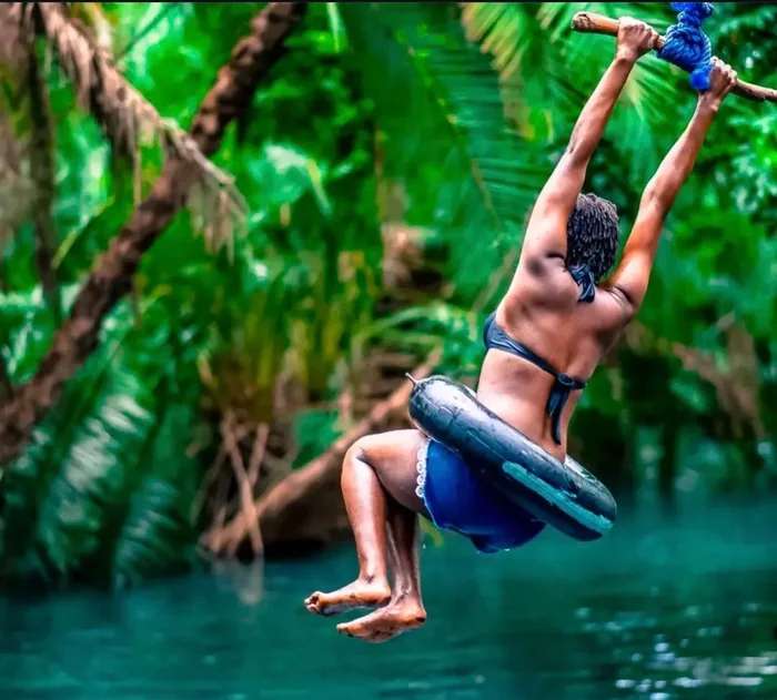Guest swinging over the water at Chemka