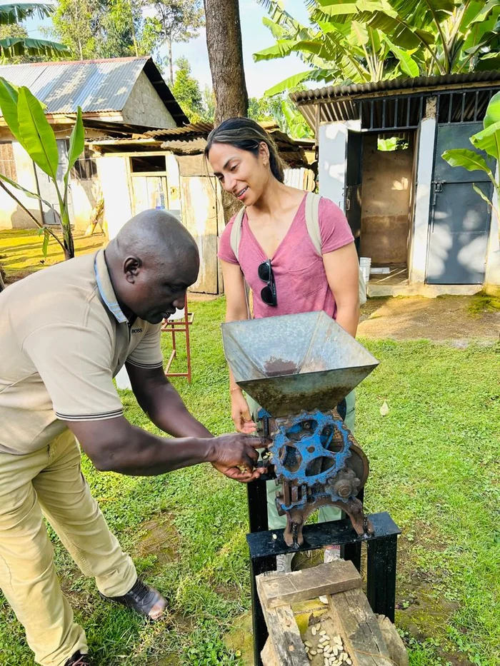 Local guide showing a guest the coffee grinder