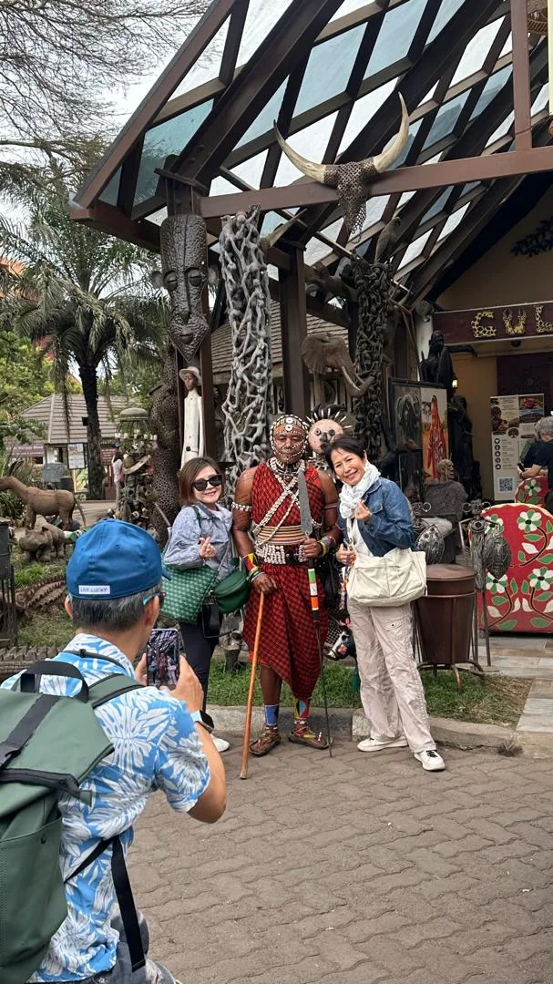 Guests posing with a Maasai warrior at the Cultural Heritage Centre