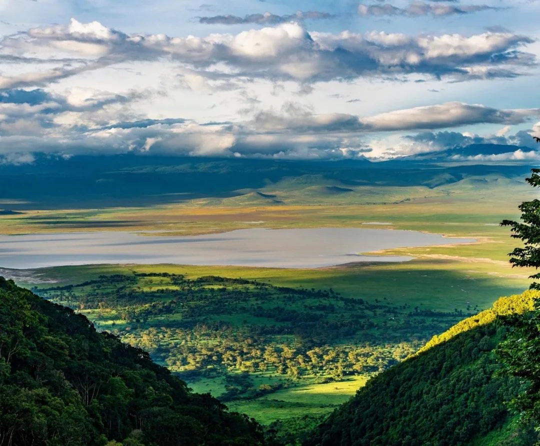 Ngorongoro Crater lake at dawn with soft clouds